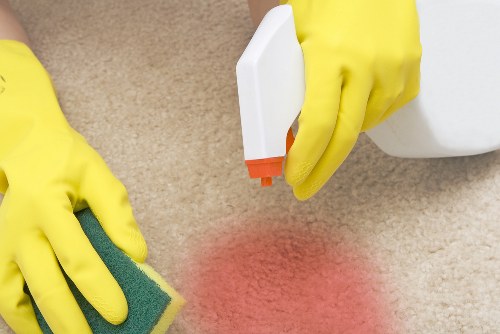 Carpet cleaning professional using safety equipment in a home setting